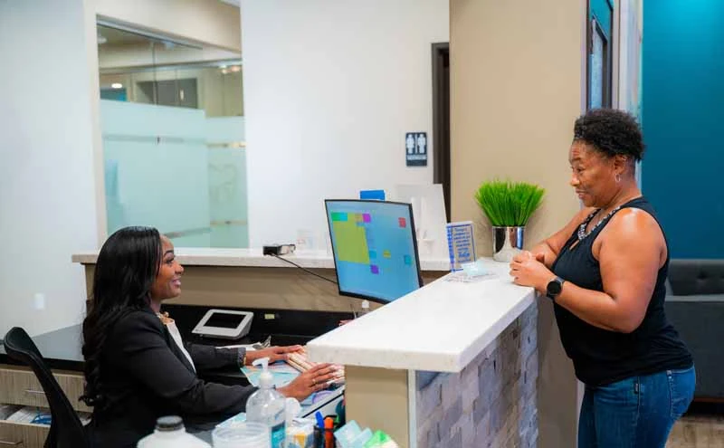 woman scheduling her next dental appointment at 10 Day Smiles